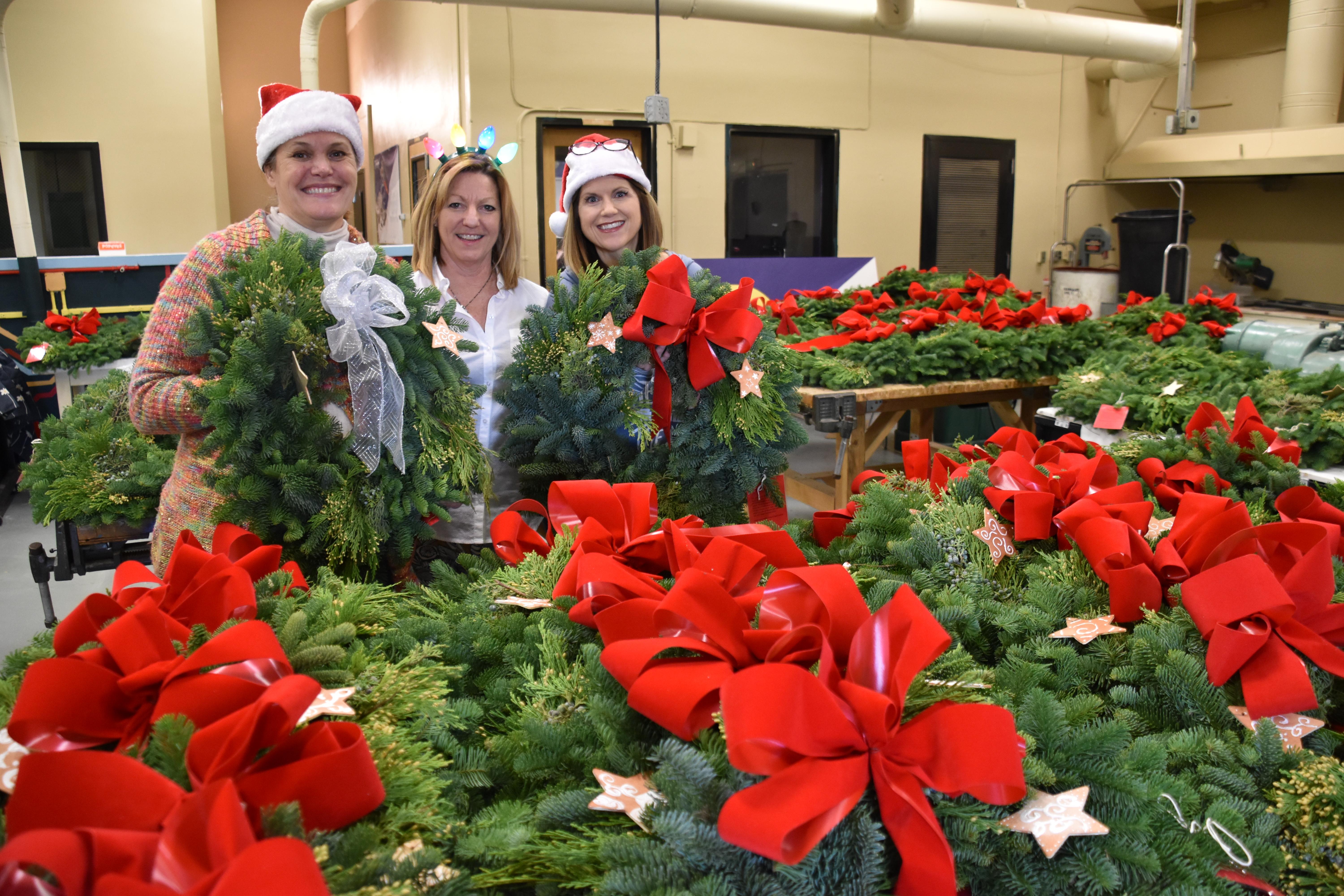 Volunteers with completed wreaths