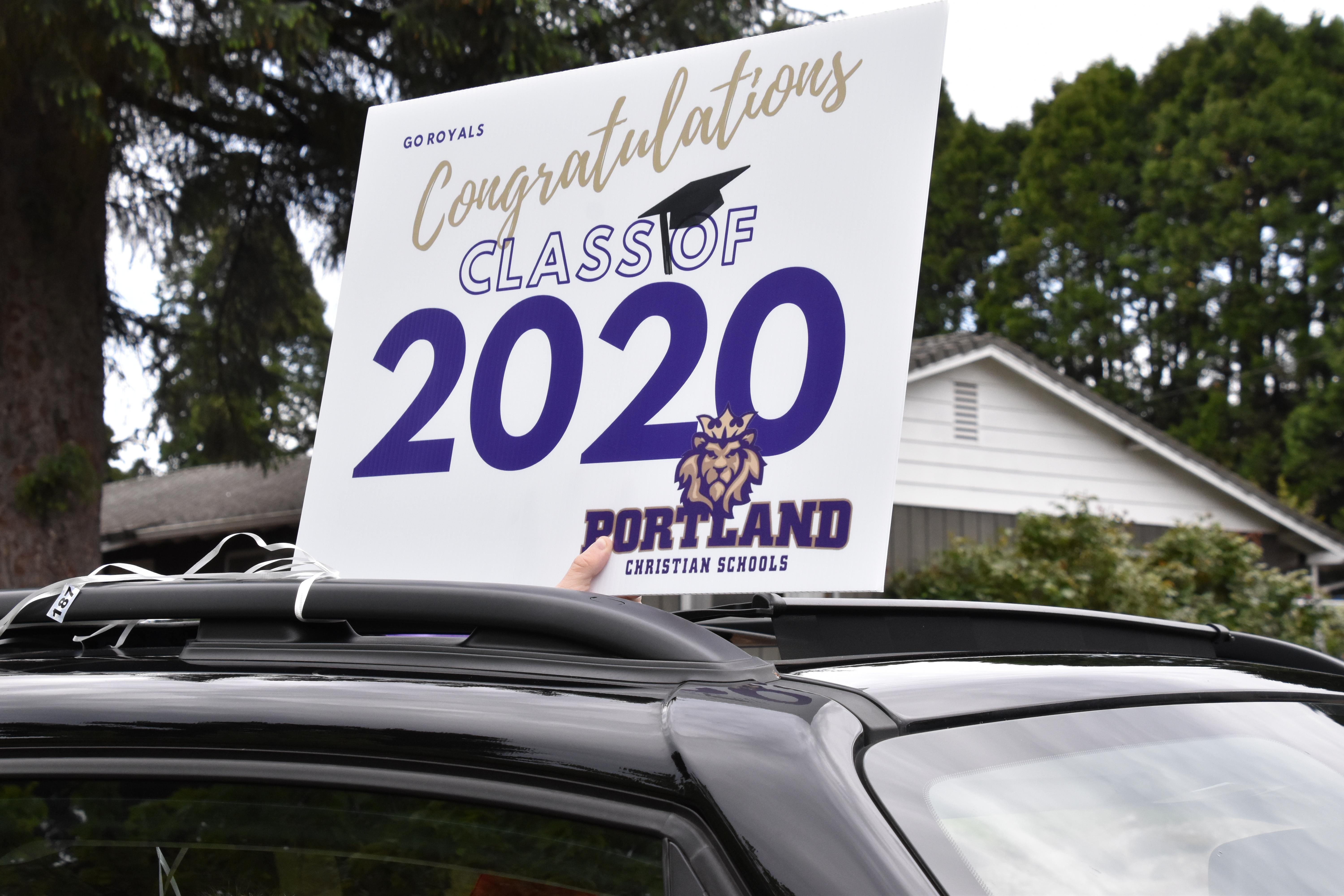 Out of car roof, the congratulations yard sign