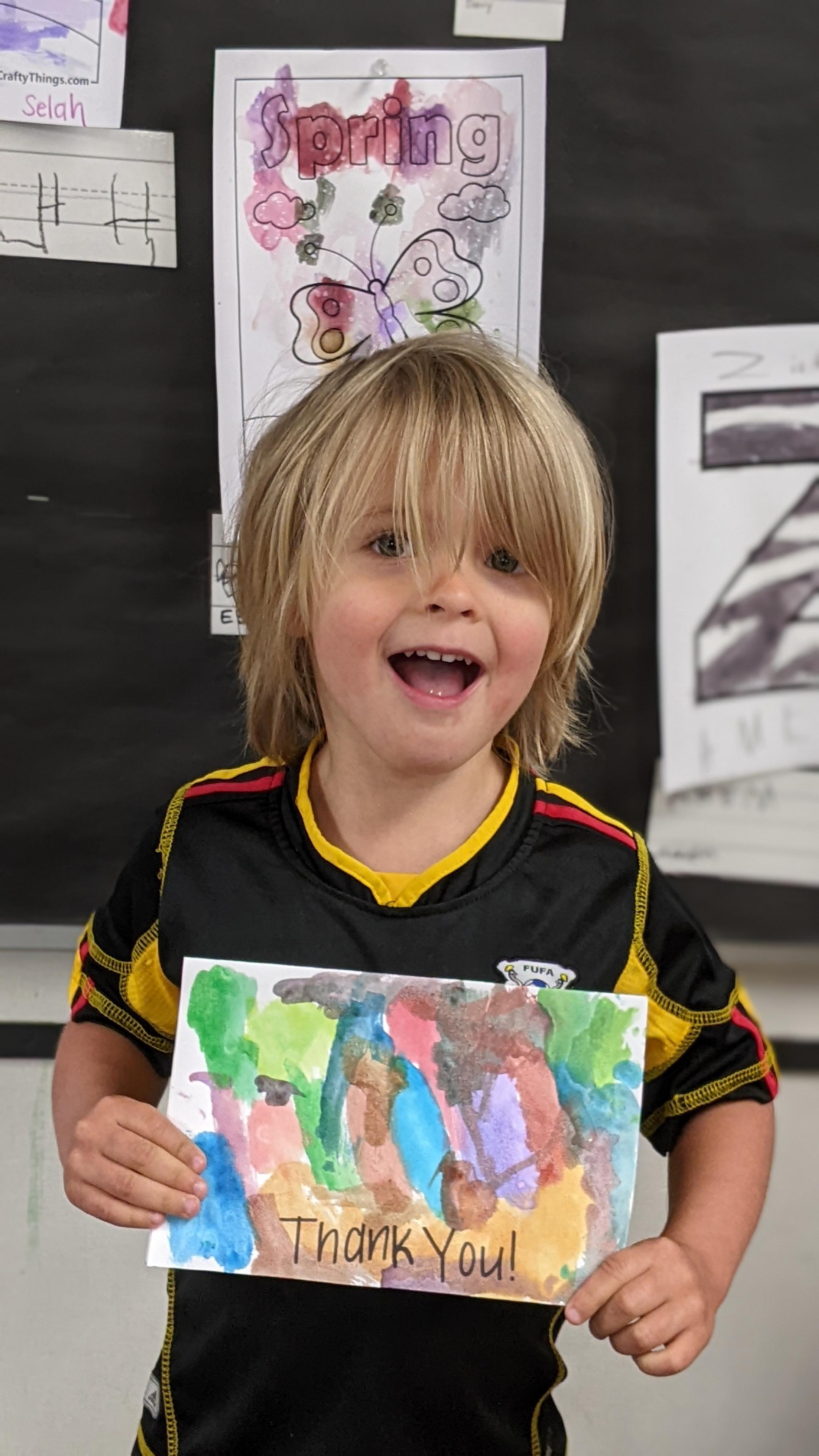 preschooler with thank you card to first responder