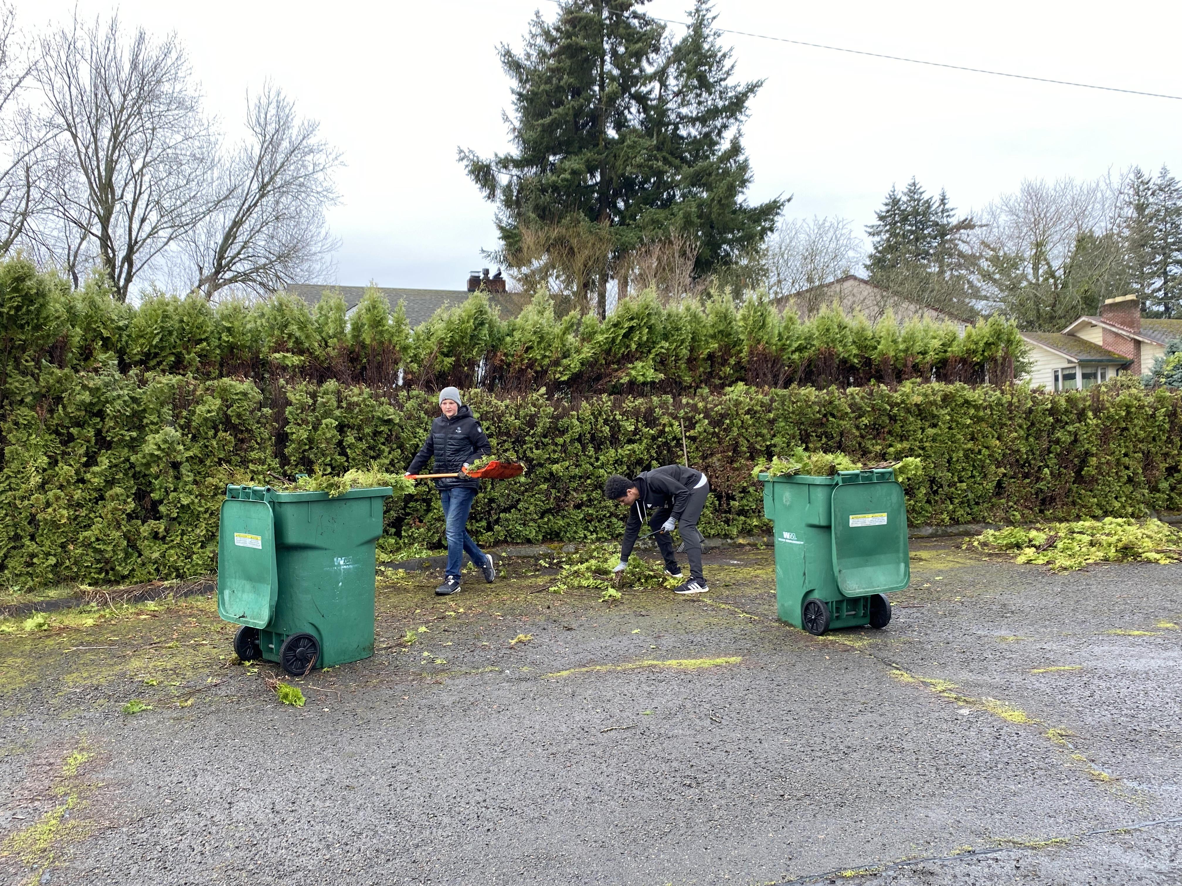 Students filling a dumpster