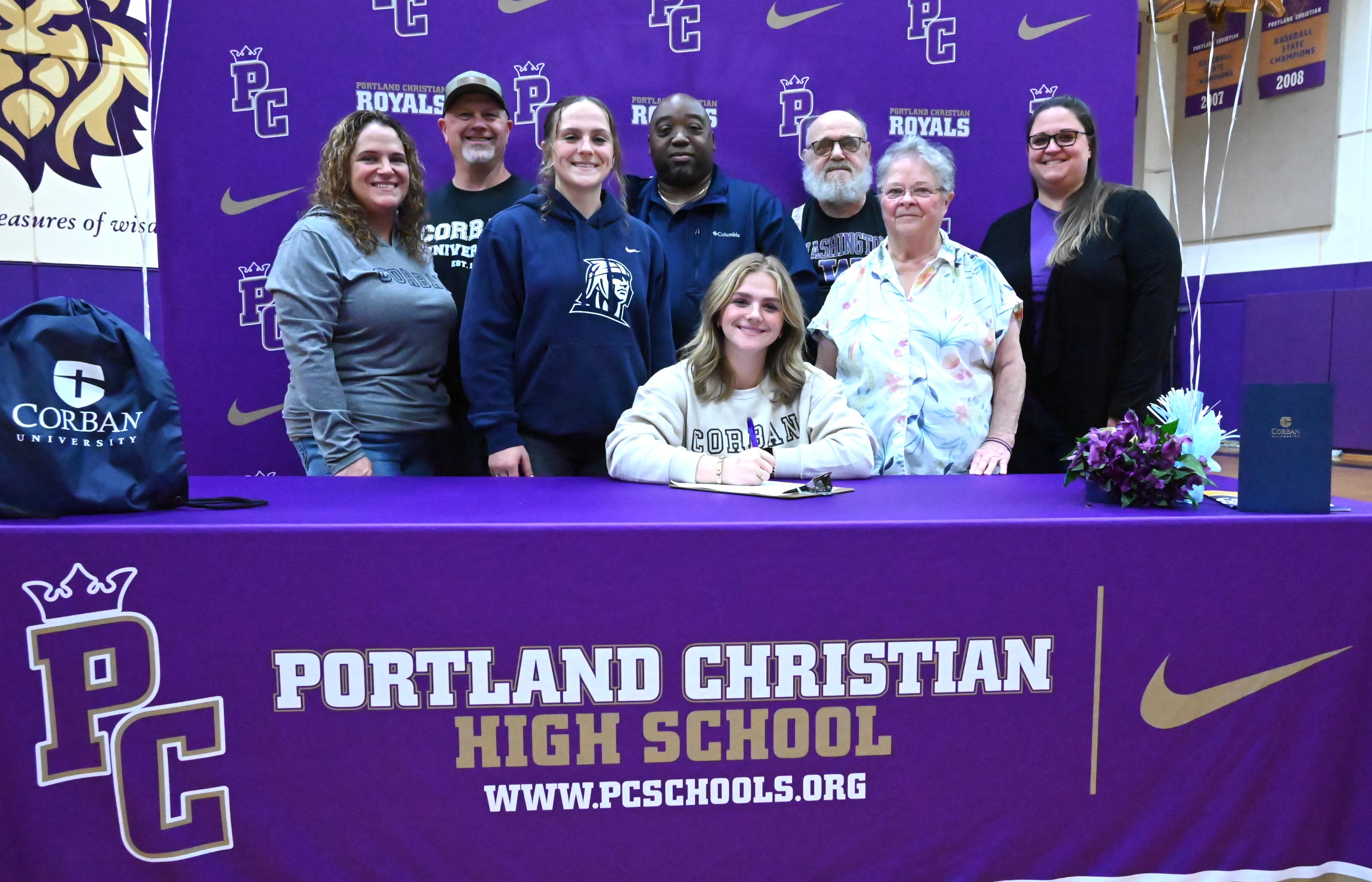 Hannah with her family and softball coaches