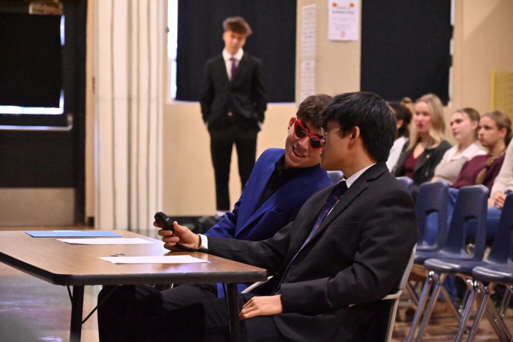 Jaxon and Paul Peterson (aka Mike) confer during the mock debate